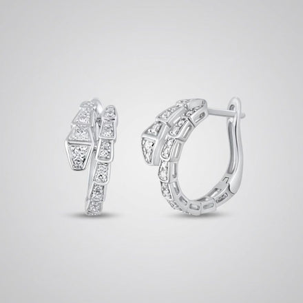 The 14k White Gold Snake Diamond Hoop Earrings 1/3CTW showcase geometric segments with sparkling natural diamonds, set in hoops displayed on a plain light gray background.
