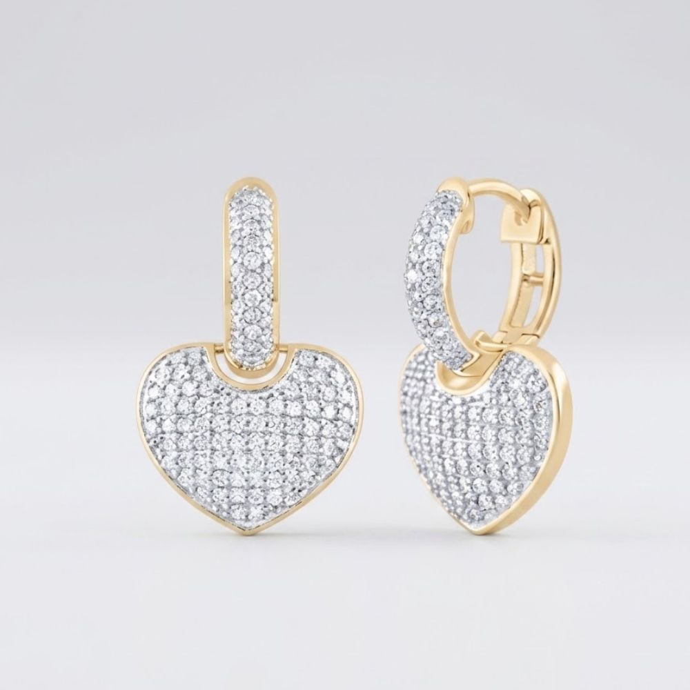 The 14k Yellow Gold Heart Diamond Hoop Earrings 7/8CTW feature heart-shaped pendants adorned with sparkling diamonds, showcased against a plain light background.