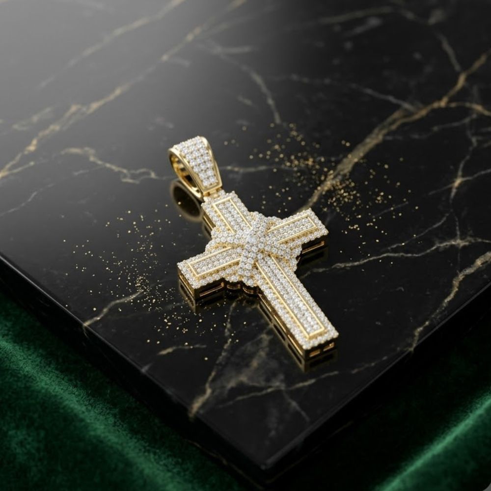 The 10K Yellow Gold Diamond Cross Pendant 7/8CTW, adorned with natural diamonds, lies on black marble with gold veins, surrounded by glittering accents as green velvet appears at the bottom edge.