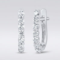 The 10k Gold Diamond Fashion Hoop Earrings 1/2CTW feature round white diamonds set in a row along the front outer edge, shown on a light gray background.