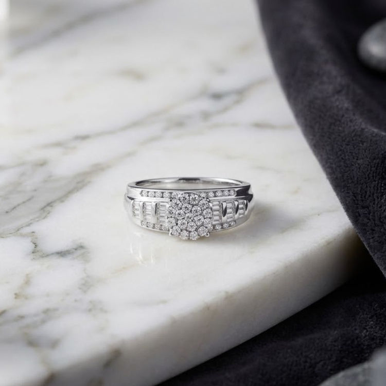 A 10k Gold Round Diamond Cluster Bridal Ring (1/2 Cttw), perfect as an engagement ring, showcases multiple sparkling diamonds arranged in an elegant cluster design and is displayed on a white marble surface beside a dark gray fabric.