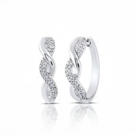 Sterling Silver Diamond Twist Hoop Earrings 1/10 Cttw feature an elegant twisted design with one side adorned in sparkling stones, shown on a white background with a subtle reflection.