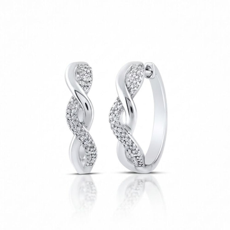 Sterling Silver Diamond Twist Hoop Earrings 1/10 Cttw feature an elegant twisted design with one side adorned in sparkling stones, shown on a white background with a subtle reflection.