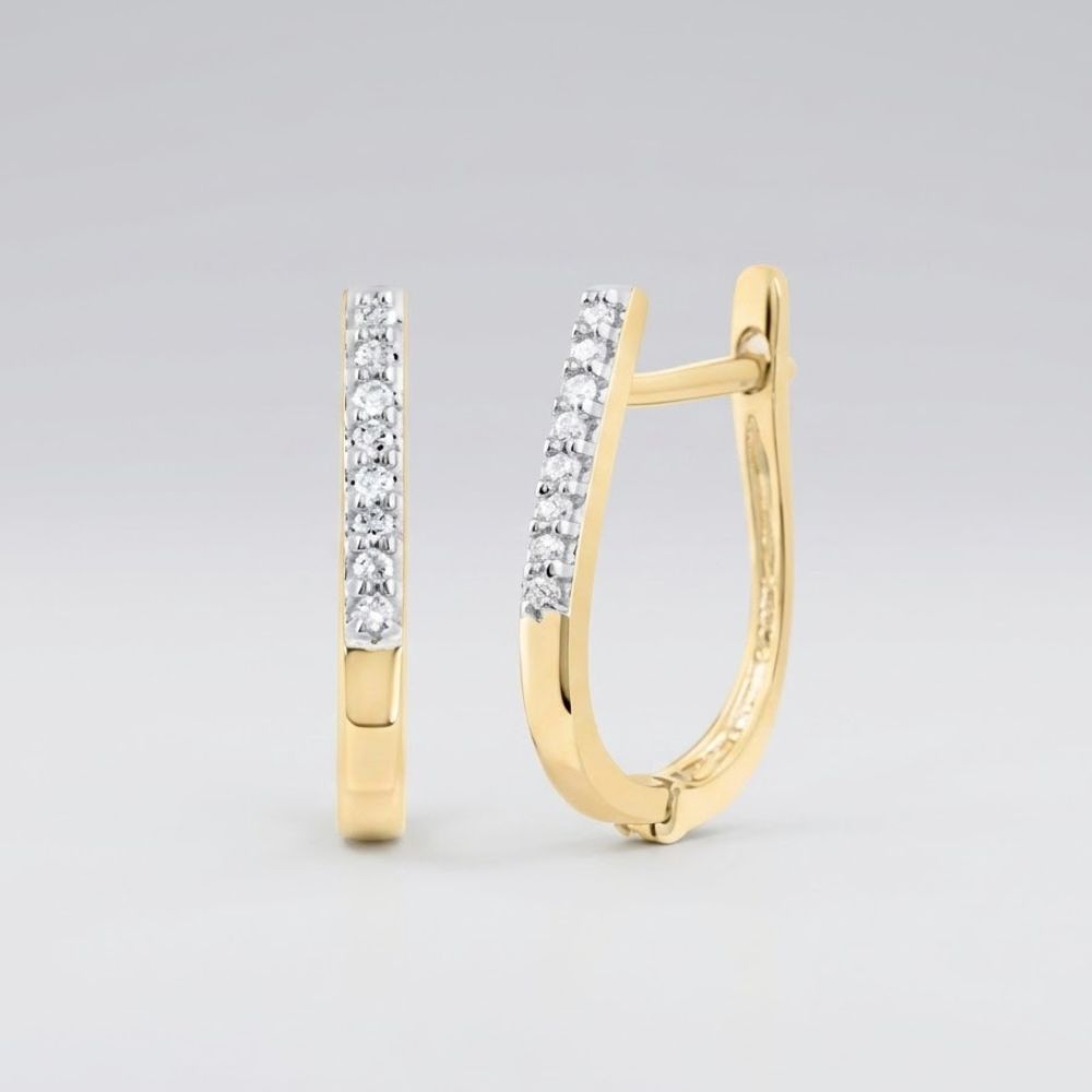 The 10k Yellow Gold Round Diamond Hoop Earrings 1/20 CTTW feature a row of sparkling diamonds along the front and are shown against a plain light gray background.