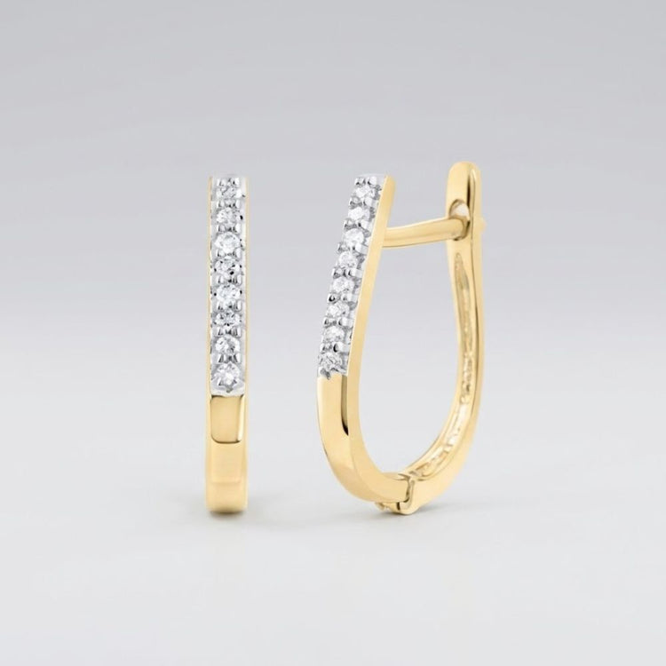 The 10k Yellow Gold Round Diamond Hoop Earrings 1/20 CTTW feature a row of sparkling diamonds along the front and are shown against a plain light gray background.