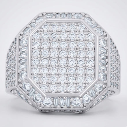The Round Moissanite Octagon Head Fashion Ring features a silver octagon head densely set with round and baguette moissanites in a sparkling geometric pattern, with the band also embellished with rows of dazzling stones.