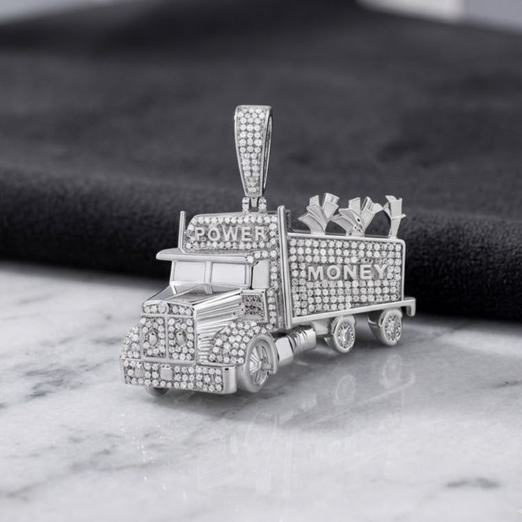 Introducing the 1CTW Diamond Truck Charm Sterling Silver Pendant—a bold and luxurious men's jewelry piece from P3. This striking pendant features a sterling silver truck encrusted with natural diamonds, with "POWER" displayed on the front and "MONEY" on the trailer, carrying shimmering money bags. Set elegantly on a marble surface against a dark textured background, this pendant perfectly embodies the distinctive style of P3 diamond men's jewelry.
