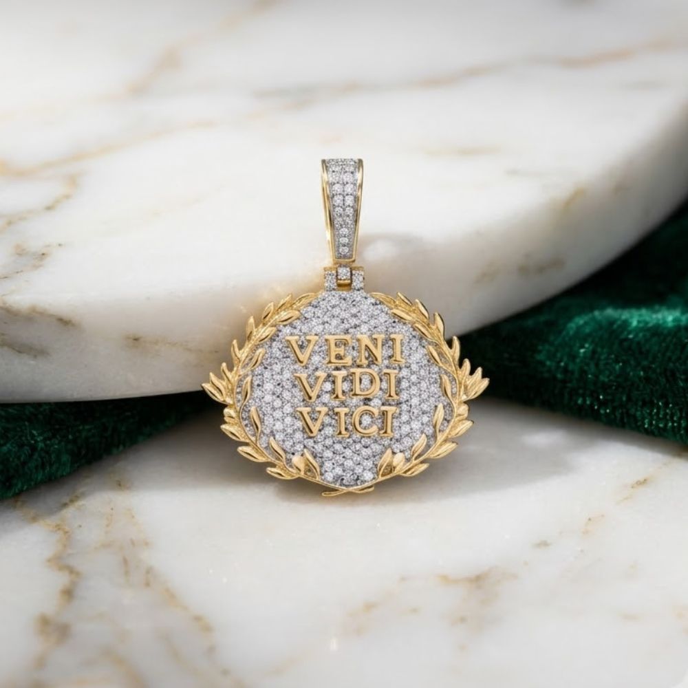 The 10K Gold Diamond Veni Vidi Vici Charm 7/8 CTW features VENI VIDI VICI in gold letters framed by a laurel wreath—a refined men’s diamond pendant from our natural diamond jewelry collection, showcased on marble.