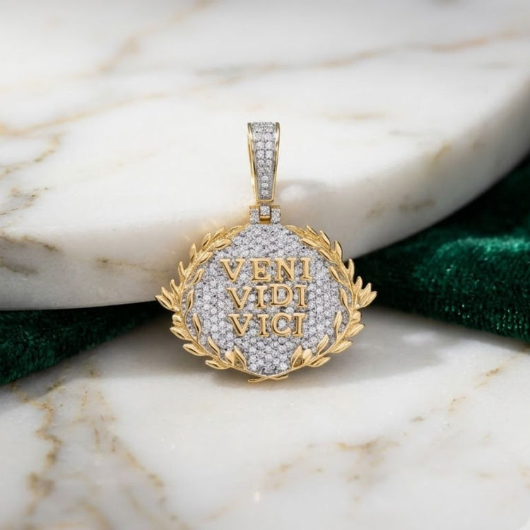 The 10K Gold Diamond Veni Vidi Vici Charm 7/8 CTW features VENI VIDI VICI in gold letters framed by a laurel wreath—a refined men’s diamond pendant from our natural diamond jewelry collection, showcased on marble.