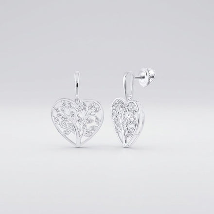 Sterling Silver Diamond Heart Dangle Earrings 1/10 Cttw featuring heart shapes, delicate leaf motifs, and sparkling diamond accents, shown against a light gray background.