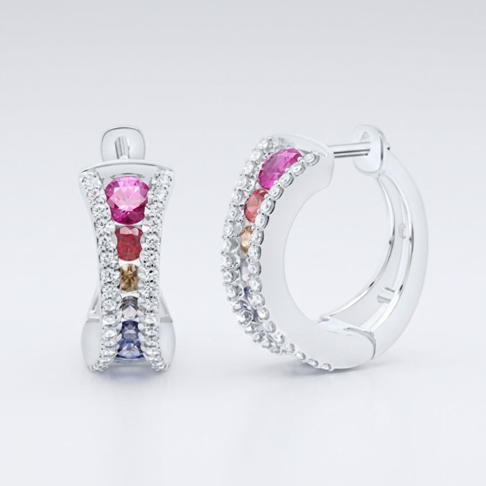 The 14k White Gold Multi Color Sapphire Hoop Earrings feature rows of clear stones and a central line of sapphire gemstones in vibrant pink, orange, brown, and blue shades.