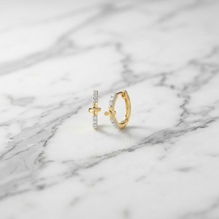 1/12CTW Natural Diamond Butterfly Hoop Earrings in 10k gold, featuring a small charm and a row of pavé-set natural diamonds.