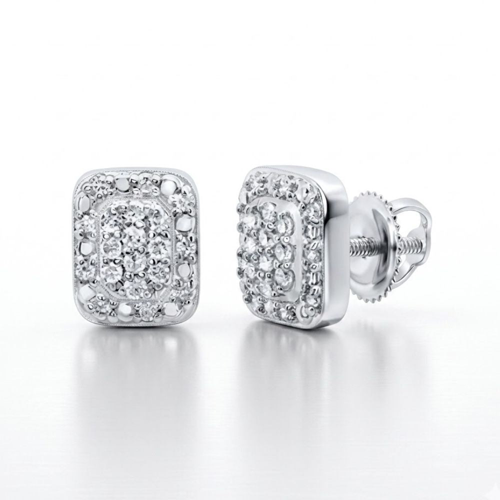 Add a touch of elegance to your collection with these 1/8CTW Diamond Emerald Earrings, crafted in sterling silver and featuring sparkling diamonds. Square-shaped with screw-back closures, they’re displayed on a white background.