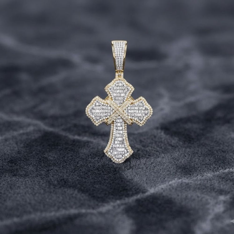The 2-1/3CTW Diamond Cross Charm for men, crafted in 10K gold, features sparkling stones and intricate details, shown on a textured dark gray surface.