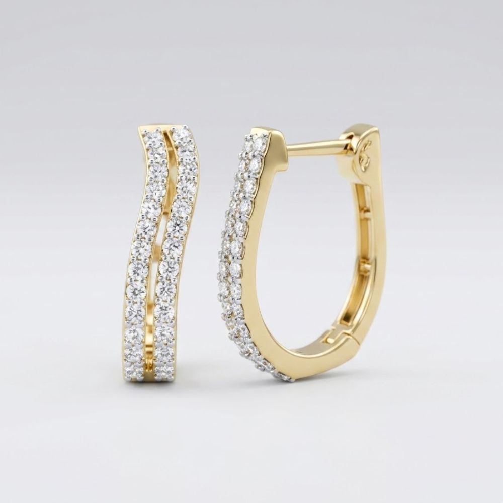 The 3/4CTW Diamond Hoop Earrings in 10k yellow gold showcase a gentle wave design with two rows of natural diamonds, photographed on a plain light gray background.