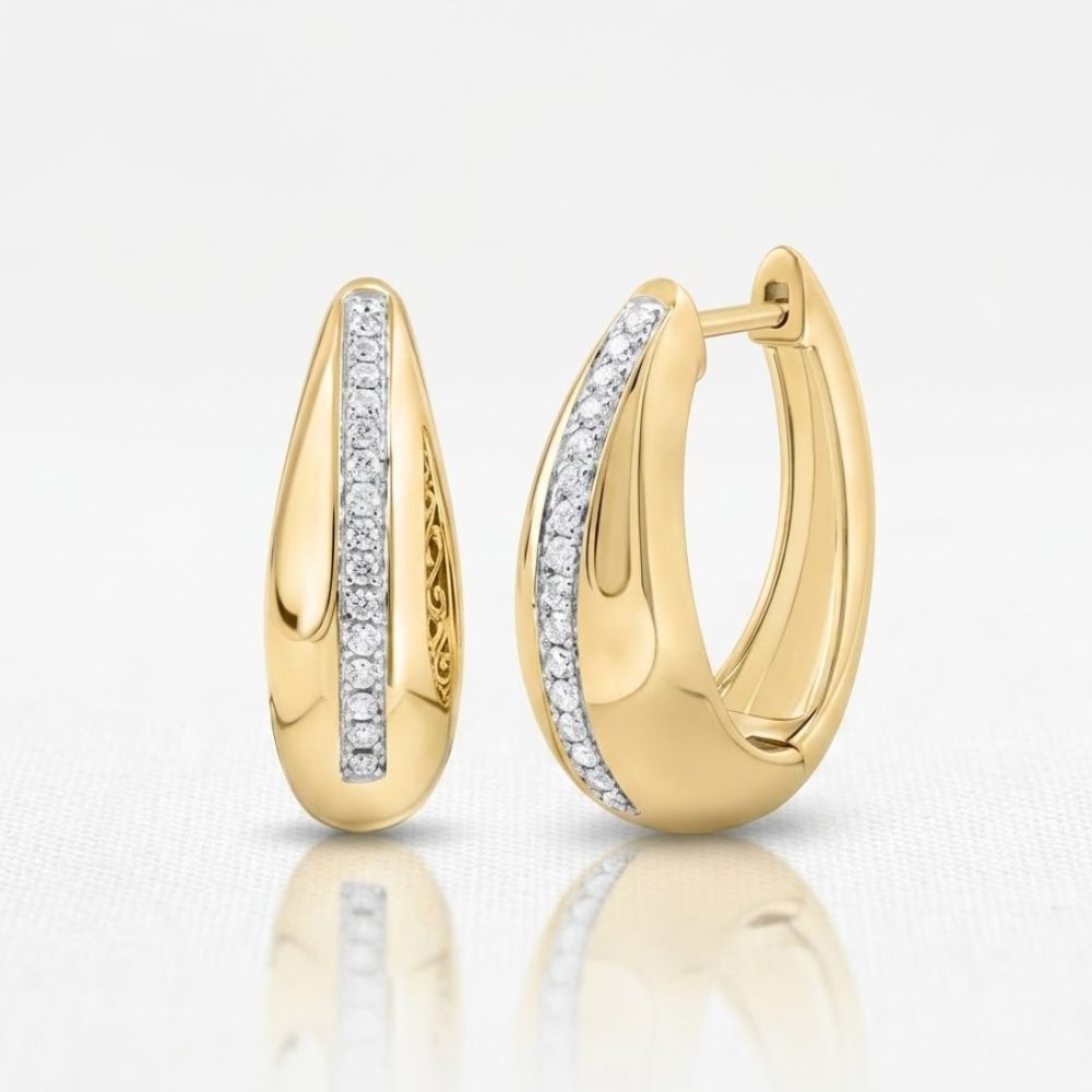 The 1/6CTW-NAT DIA CN FASHION HOOP EARRING is a pair of 10K yellow gold hoops adorned with a vertical row of sparkling natural diamonds on the front, shown against a plain white background.