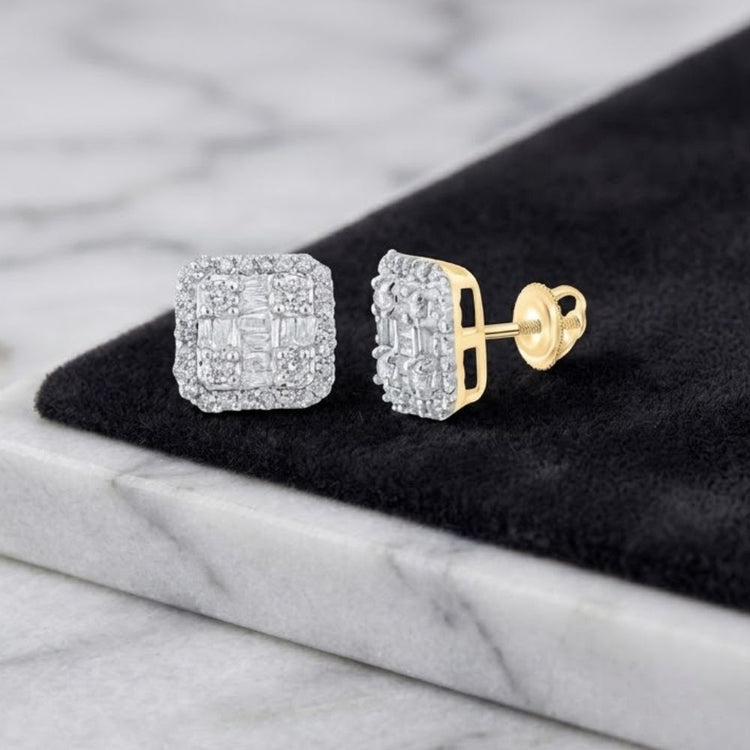 A pair of 10k Yellow Gold Baguette Diamond Square Earrings with gold backs, elegantly displayed on a black and white marble surface.