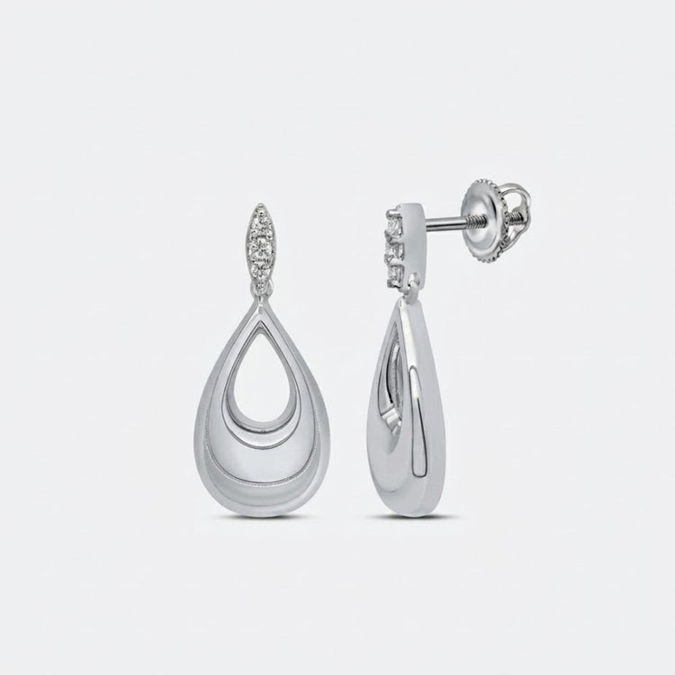 The 1/8CTW Diamond Pear Earrings in sterling silver feature a layered teardrop design with round diamond accents, polished finish, and secure screw-back closure—an elegant diamond gift.