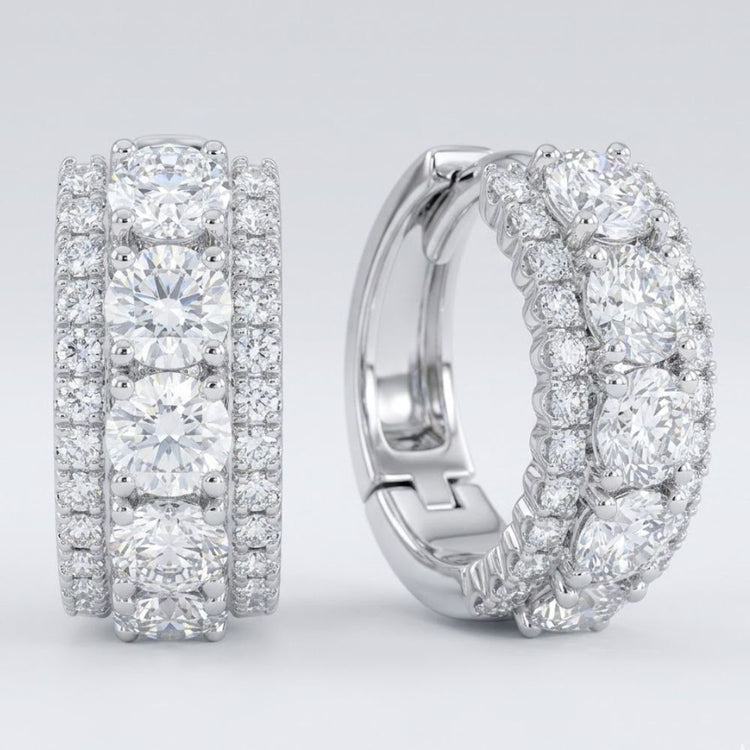 Elegant 14k white gold diamond 3-row huggie earrings (1 cttw) featuring rows of sparkling round-cut diamonds, displayed on a light gray background.