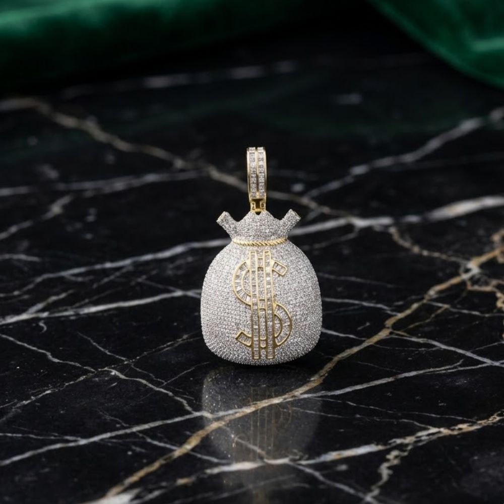 The 10K Gold Diamond Money Bag Pendant 4 1/3CTW, crafted for men in yellow gold and set with sparkling diamonds, showcases a bold dollar sign design and is displayed on a black marble surface with a green fabric accent in the background.