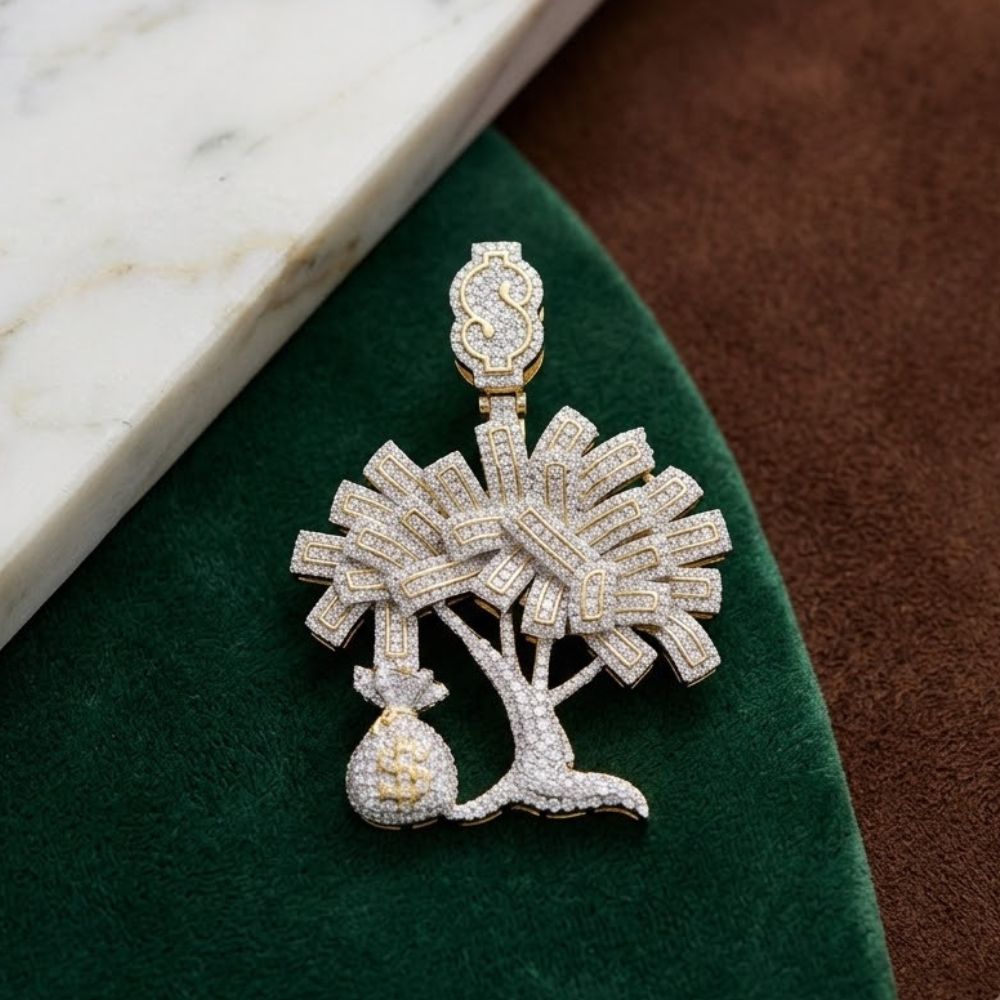 The 10K Gold Diamond Money Tree Charm Pendant (2.75 CTW) features a palm tree with crossed swords and a money bag—an ideal hip hop jewelry piece, shown on green and brown fabric beside white marble.