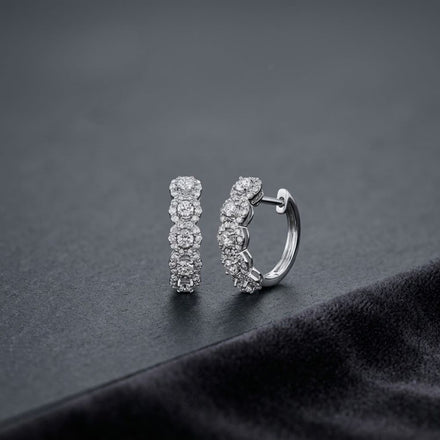 14k White Gold Round Diamond Halo Hoop Earrings featuring a pair of 14k white gold hoop earrings with a row of circular clusters of round diamonds.