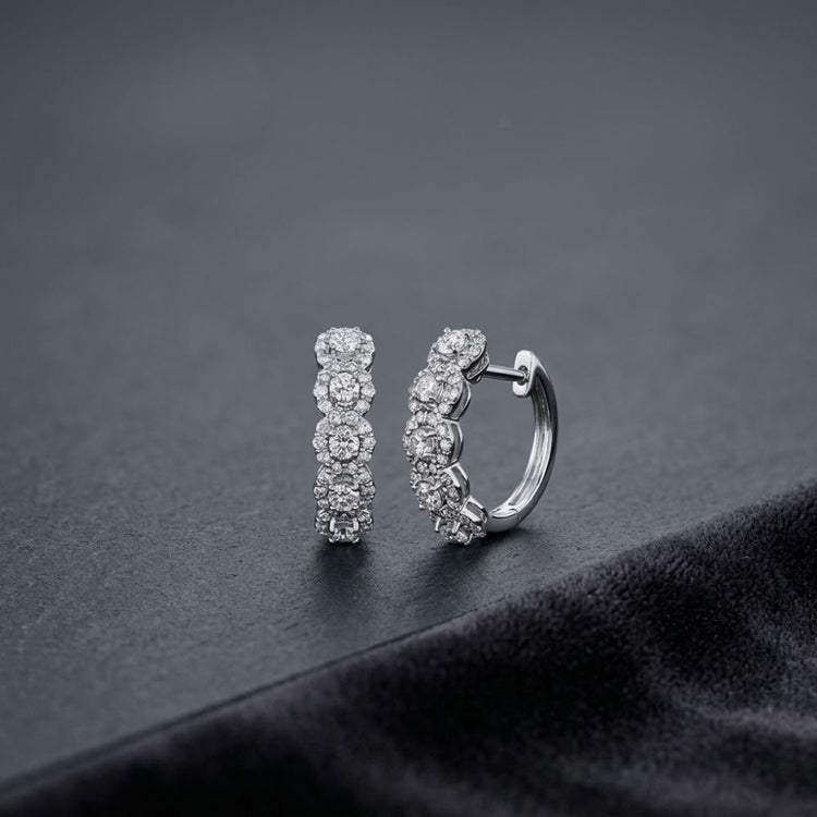 14k White Gold Round Diamond Halo Hoop Earrings featuring a pair of 14k white gold hoop earrings with a row of circular clusters of round diamonds.