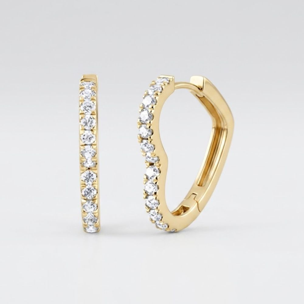 The 14k Yellow Gold Heart Diamond Hoop Earrings 1/2CTW feature a chic row of sparkling diamonds along the front edge, set in yellow gold and displayed against a simple light background—a stylish update on classic hoops.