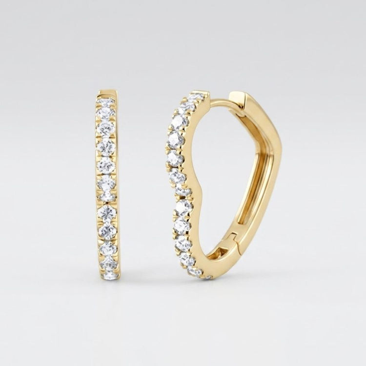 The 14k Yellow Gold Heart Diamond Hoop Earrings 1/2CTW feature a chic row of sparkling diamonds along the front edge, set in yellow gold and displayed against a simple light background—a stylish update on classic hoops.