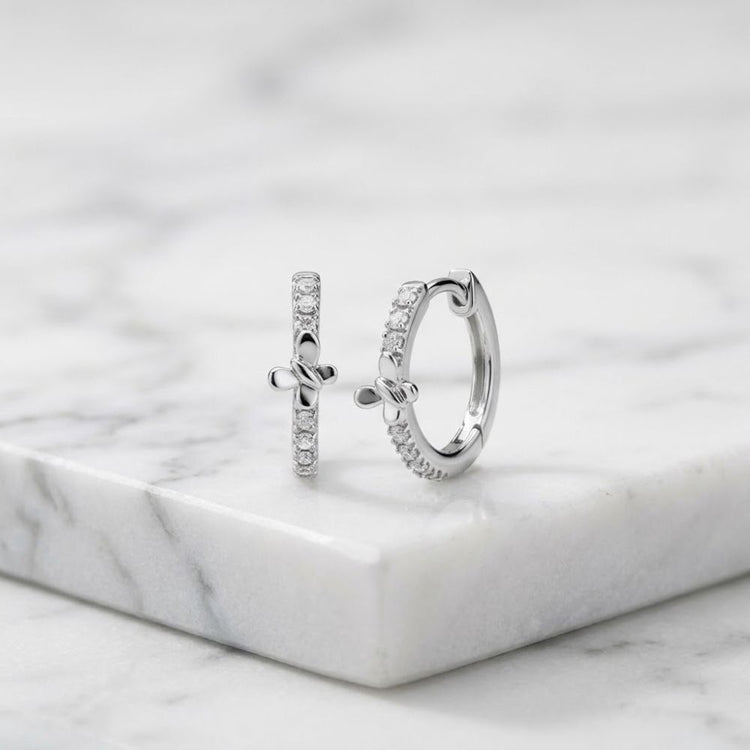 1/12CTW Natural Diamond Butterfly Hoop Earrings featuring two silver butterfly hoops with a row of natural diamond accents.