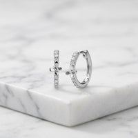 1/12CTW Natural Diamond Butterfly Hoop Earrings featuring two silver butterfly hoops with a row of natural diamond accents.