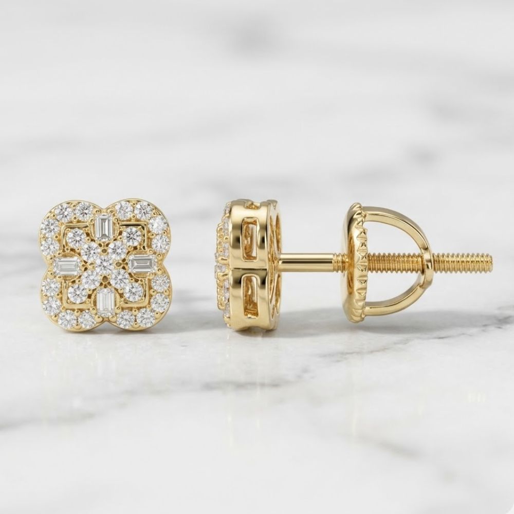 A pair of Silver Yellow Moissanite Clover Stud Earrings with a floral design, featuring round and baguette stones, displayed on a white marble surface.