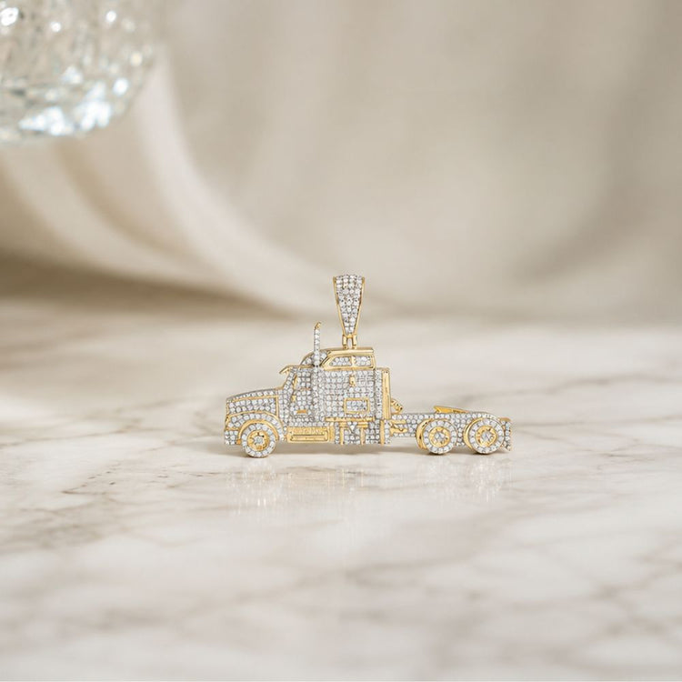 Showcased on a white marble surface with a softly blurred background, the 10k Yellow Gold Diamond Truck Charm 1 1/4 Cttw is an eye-catching men’s pendant fashioned as a semi truck and adorned with sparkling diamonds. This unique piece of truck jewelry radiates elegance and style.