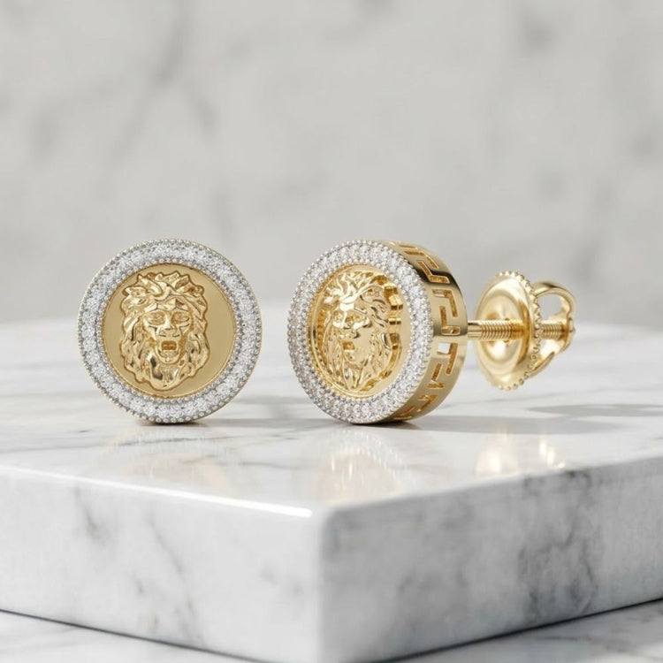 A pair of 10K yellow gold cufflinks with detailed lion heads and a border of sparkling stones, displayed on white marble. Pairs perfectly with our 1/4CTW Diamond Lion Stud Earrings for Men in 10K yellow gold for a bold statement look.