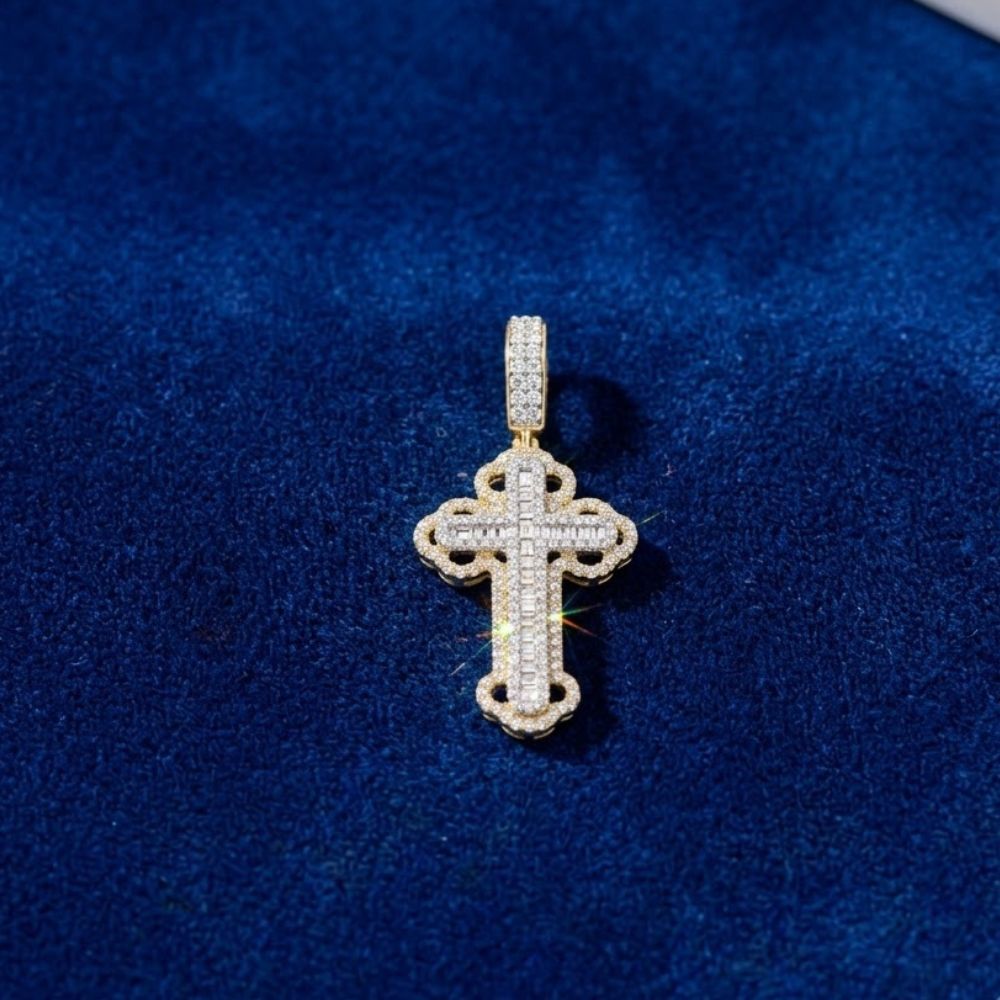 The Diamond Cross Charm 3/4CT 10K Gold, featuring small diamonds set in yellow gold, rests on dark blue velvet—an elegant piece of natural diamond men's jewelry.
