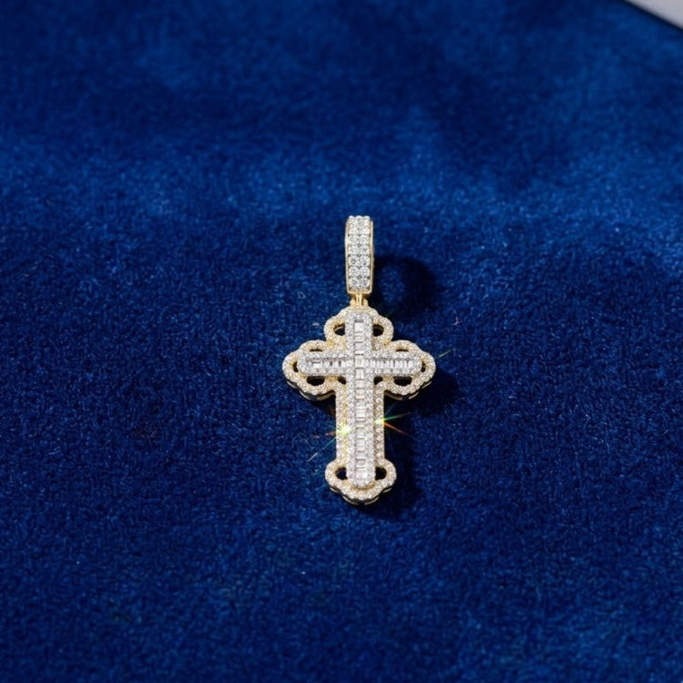 The Diamond Cross Charm 3/4CT 10K Gold, featuring small diamonds set in yellow gold, rests on dark blue velvet—an elegant piece of natural diamond men's jewelry.