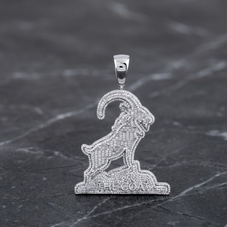 Certainly! Here’s a revised version using your product data: The 2-7/8CTW Natural Diamond Goat Charm Sterling Silver features a men’s sterling silver pendant shaped like a goat standing on a rocky base engraved with THE GOAT, set against a dark marble background—an eye-catching diamond charm that makes for striking natural diamond jewelry.