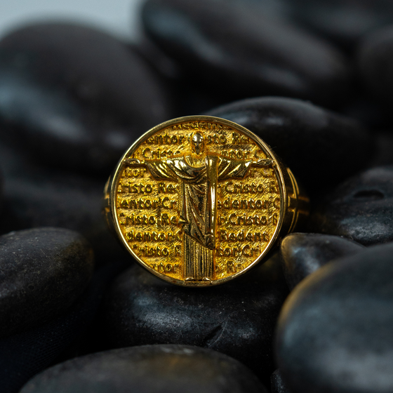 Front Image of Circular Jesus Men's Ring on rocks. Crafted in 14k Solid Yellow Gold, stamped for authenticity. | GOLDZENN 