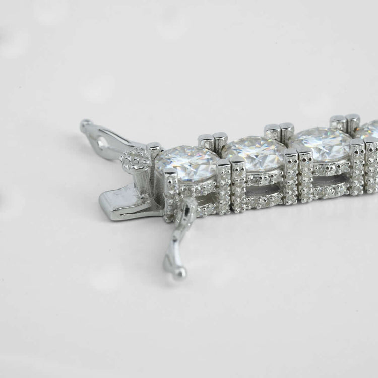 Close-up of the Fully Iced Out Moissanite Tennis Bracelet, crafted in 925 sterling silver with large round clear moissanite stones and sparkling accents—a stunning choice for any occasion, shown against a plain white background.