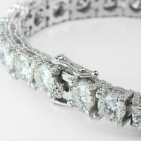 Close-up of the Fully Iced Out Moissanite Tennis Bracelet crafted in elegant 925 sterling silver, showcasing large round-cut clear gemstones in prong settings and a detailed locking clasp, set against a white background.