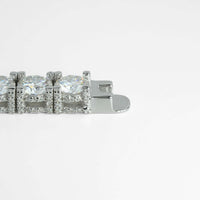 A close-up of a 925 sterling silver clasp on the Fully Iced Out Moissanite Tennis Bracelet, featuring large round clear gemstones and small sparkling stones, set against a plain white background.