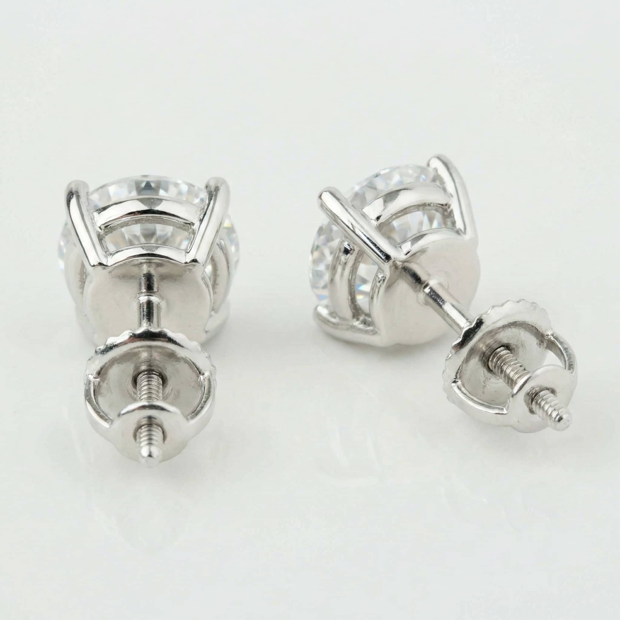 The 14k Classic Round Lab Diamond Four Prong Stud Earrings (F/G VS+) are shown from the back, highlighting their secure screw-back posts and settings on a white background.