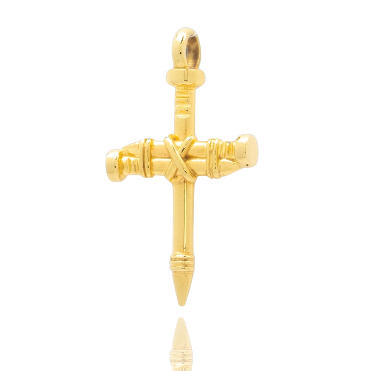 The Gold Nail Cross Pendant, designed as three nails bound together, features a polished finish and is offered in 10K or 14K gold. Shown against a white background, this striking Christian jewelry piece blends faith with elegance.