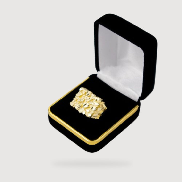 The Gold Nugget Ring - 10k Solid Gold features a textured design and is displayed in a black velvet jewelry box with white lining and gold trim, set against a light gray background—a bold accessory for any occasion.