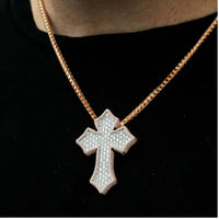 A close-up of the Gothic Lab Diamond Cross Pendant, a 14k gold necklace featuring a large diamond-encrusted cross, worn over a black shirt.