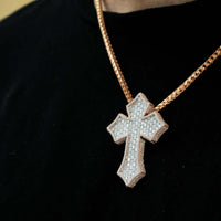 Someone wears the Gothic Lab Diamond Cross Pendant on a gold chain necklace over a black shirt.