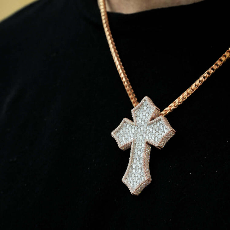 Someone wears the Gothic Lab Diamond Cross Pendant on a gold chain necklace over a black shirt.