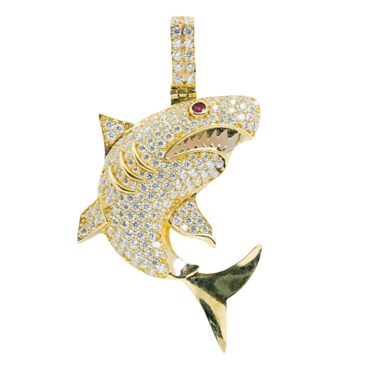 The 14k Gold Great White Shark Pendant – Men’s Gold Pendant features a shark design with clear gemstones, a red gemstone eye, gold teeth in an open mouth, and a greenish-hued tail for a striking luxury jewelry look.