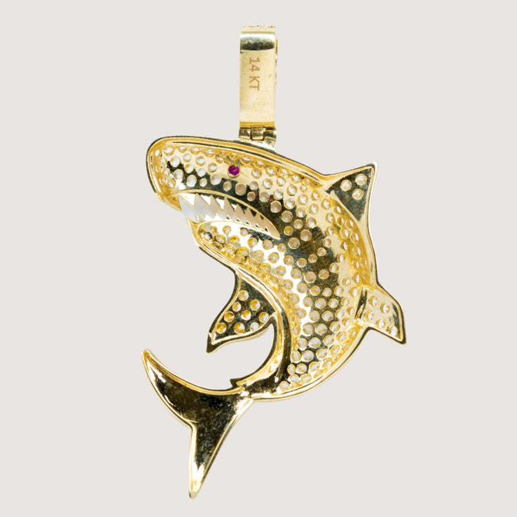 The 14k Gold Great White Shark Pendant – Men’s Gold Pendant features a detailed, textured design with a red eye and sharp white teeth. The bail is stamped "14 KT," making it ideal for shark jewelry enthusiasts seeking luxury style.