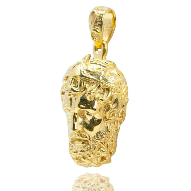 The Greek Poseidon Pendant is a 14K gold men’s pendant shaped like Poseidon's head, featuring detailed curly hair and a crown, with a loop at the top for easy attachment to a chain.